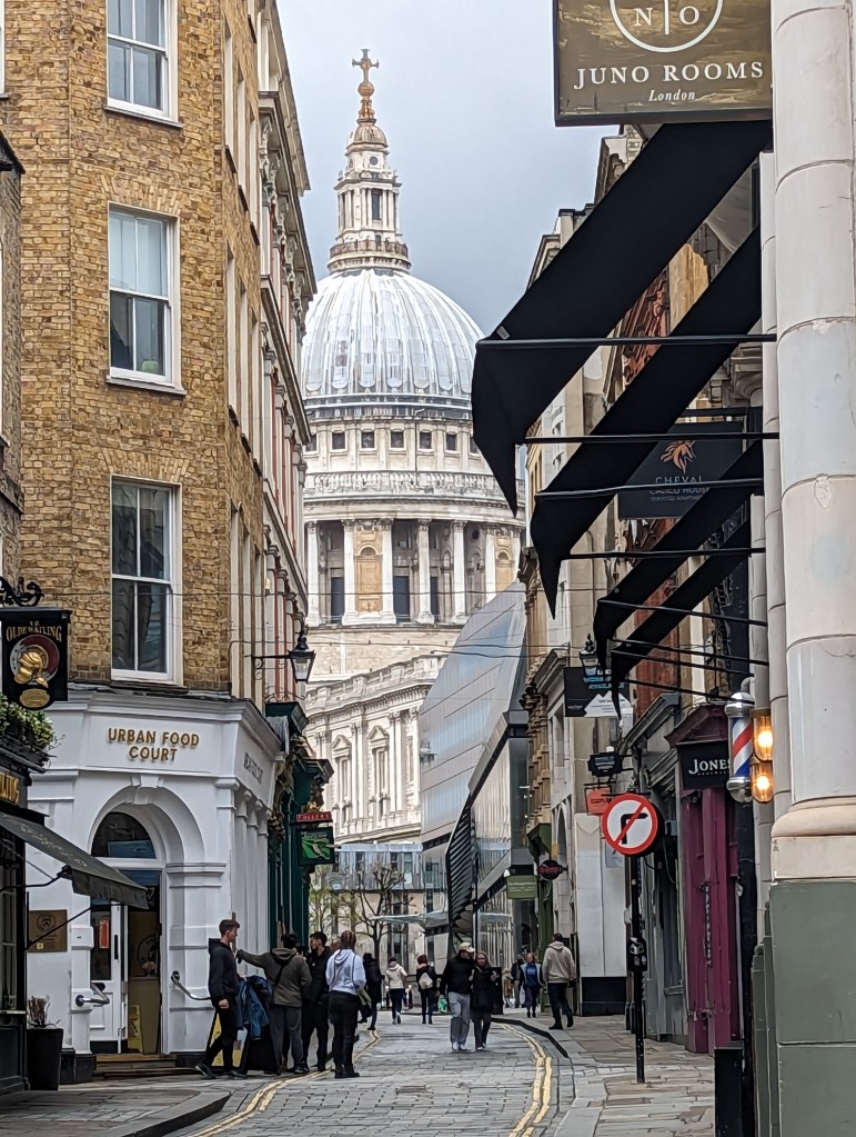 A walk up Watling Street in the City of London with St Paul's Cathedral framed by grey skies