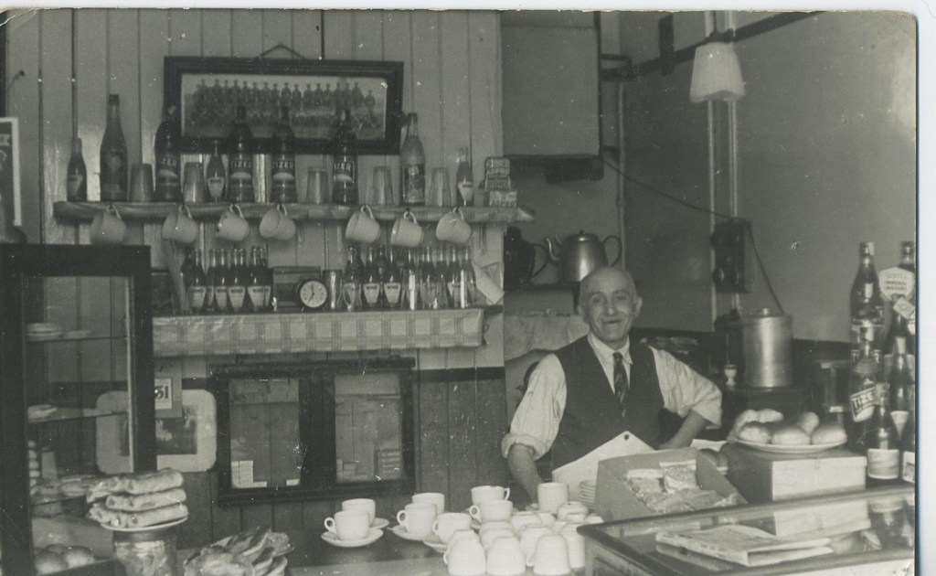 A black and white photograph of a cafe in the early 1950s