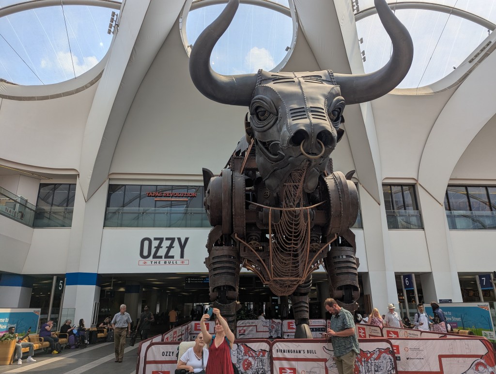 A large, metal bull, with a sign saying Ozzy.