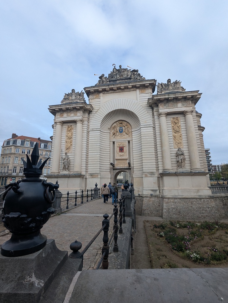 A grand white stone gateway, with statues and turrets